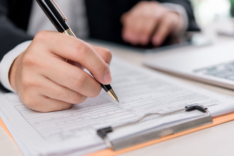 Business financial paperwork and contract documents on desk