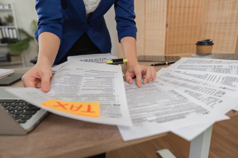 Professional organizing tax documents and GST paperwork on desk
